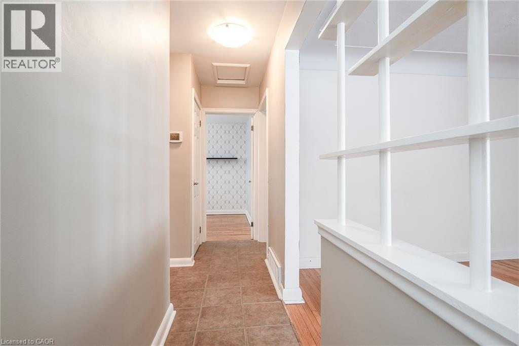 Hall with attic access, wallpapered walls, and light tile patterned floors - 120 Fourth Avenue, Kitchener, ON - Indoor Photo Showing Other Room