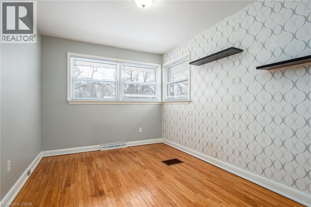 Unfurnished room featuring light wood-type flooring, wallpapered walls, and healthy amount of natural light - 120 Fourth Avenue, Kitchener, ON - Indoor Photo Showing Other Room