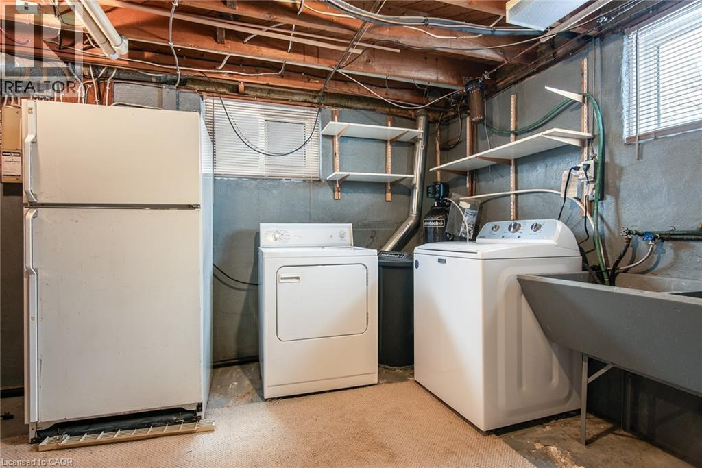Washroom featuring washer and dryer and unfinished concrete floors - 120 Fourth Avenue, Kitchener, ON - Indoor Photo Showing Laundry Room