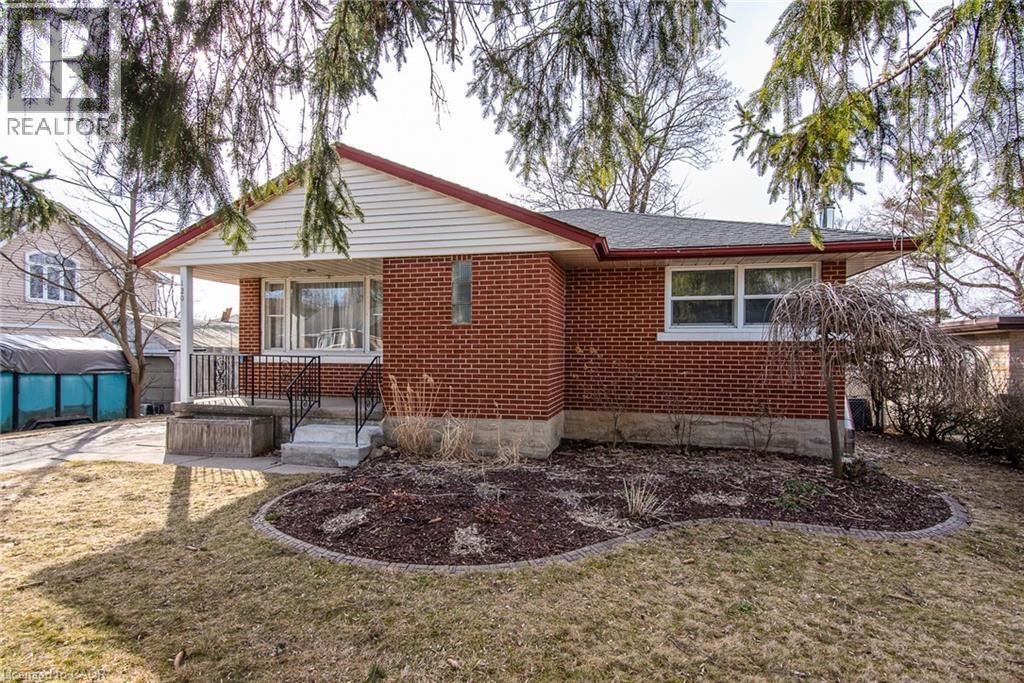 Back of property with brick siding, a yard, and a patio area - 120 Fourth Avenue, Kitchener, ON - Outdoor With Deck Patio Veranda