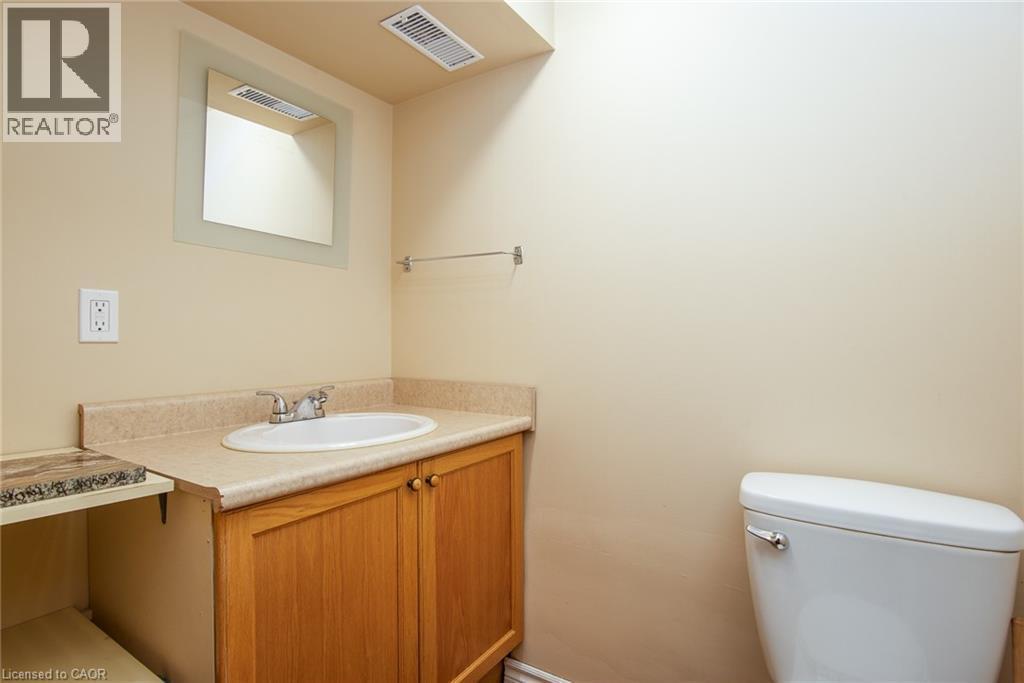 Half bathroom featuring vanity and toilet - 120 Fourth Avenue, Kitchener, ON - Indoor Photo Showing Bathroom