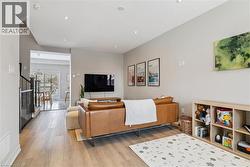 Living area featuring light wood-style flooring and recessed lighting -