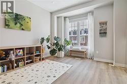 Living area featuring light wood-type flooring and baseboards -