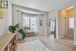 Living area featuring arched walkways, light wood-style floors, recessed lighting, and a textured ceiling -