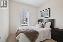 Bedroom with carpet floors and baseboards -