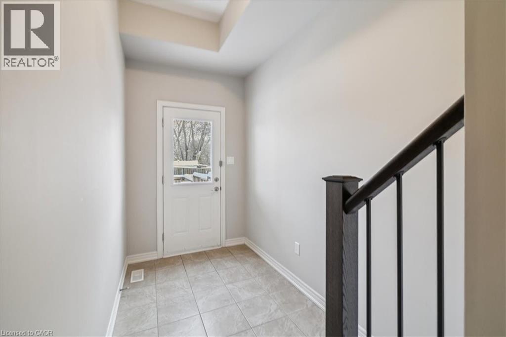 Foyer entrance featuring stairs and light tile patterned floors - 2220 Queensway Drive Unit# 15, Burlington, ON - Indoor Photo Showing Other Room