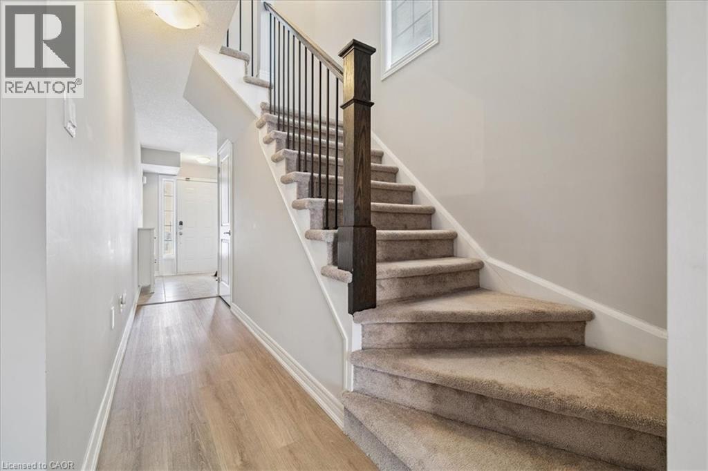 Stairs featuring a towering ceiling and wood finished floors - 2220 Queensway Drive Unit# 15, Burlington, ON - Indoor Photo Showing Other Room