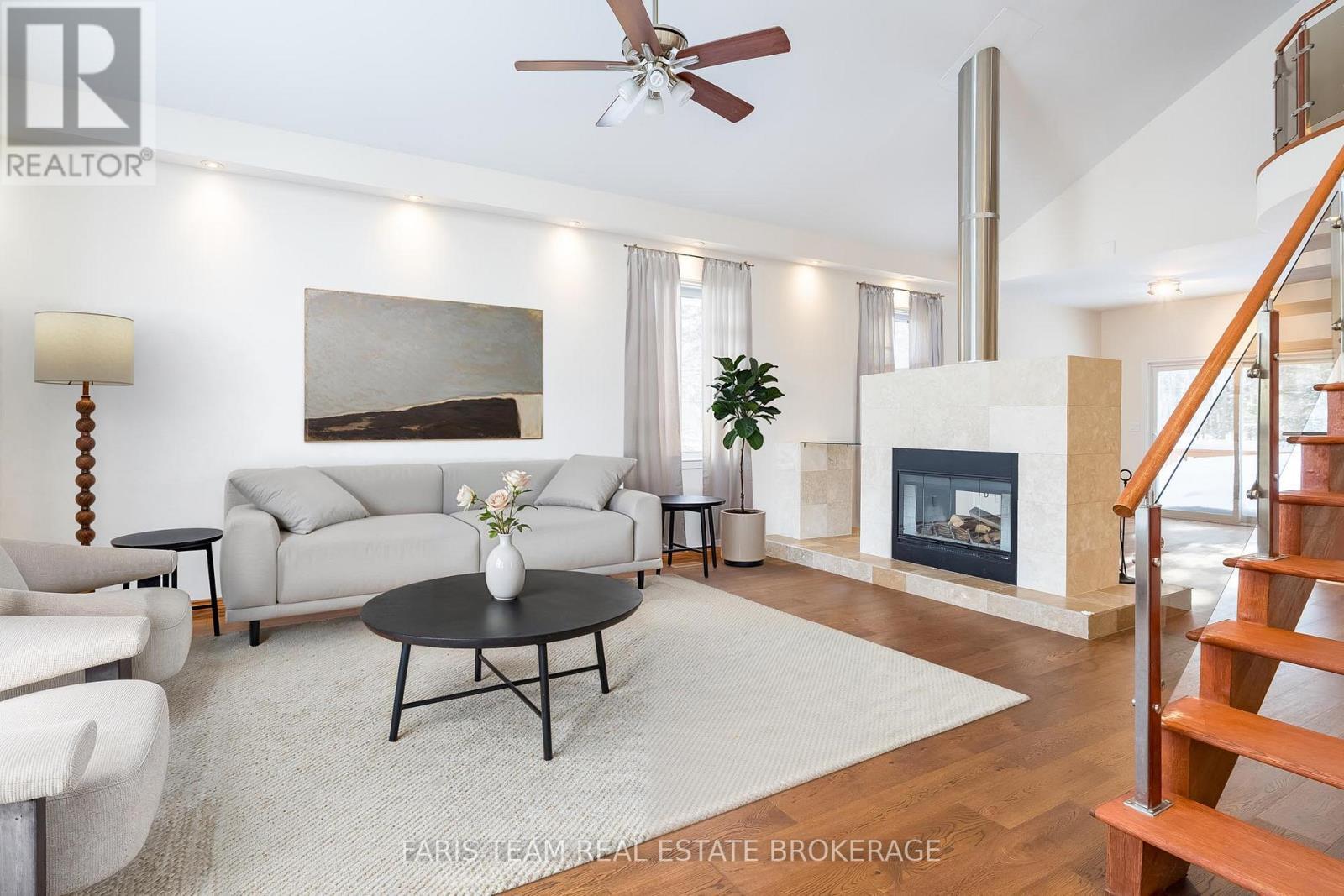 Virtually Staged - 2384 Champlain Road, Tiny, ON - Indoor Photo Showing Living Room With Fireplace