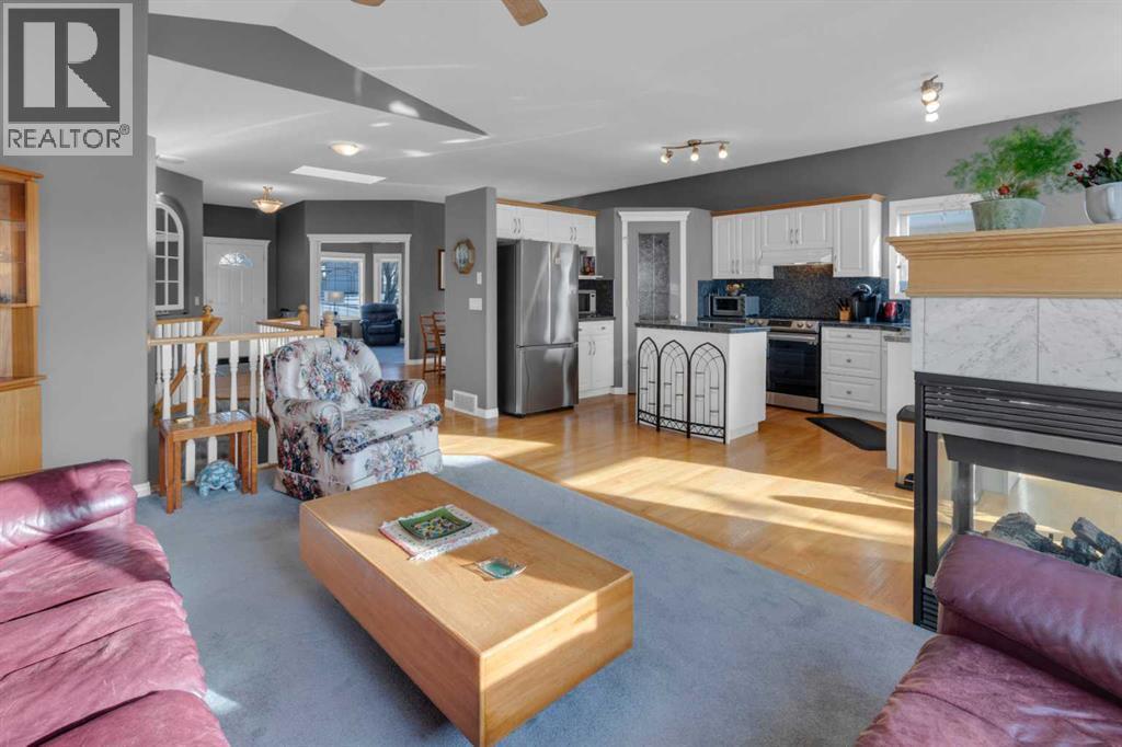 53 Scimitar Heath Nw, Calgary, AB - Indoor Photo Showing Living Room With Fireplace