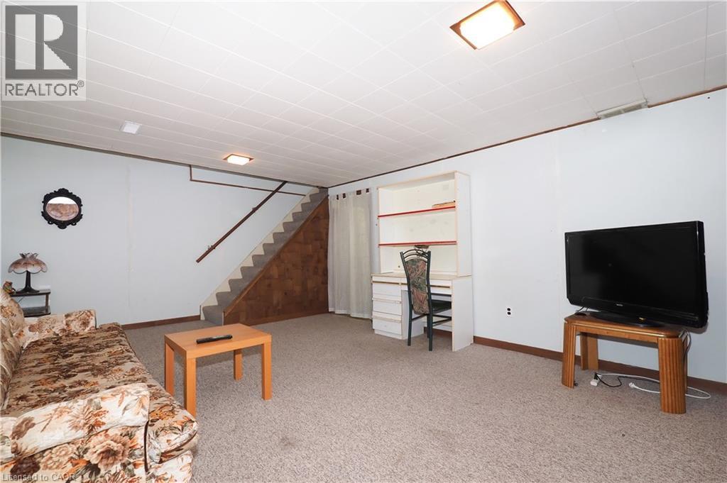 Living area featuring light carpet and stairway - 10 Balfour Crescent, Kitchener, ON - Indoor