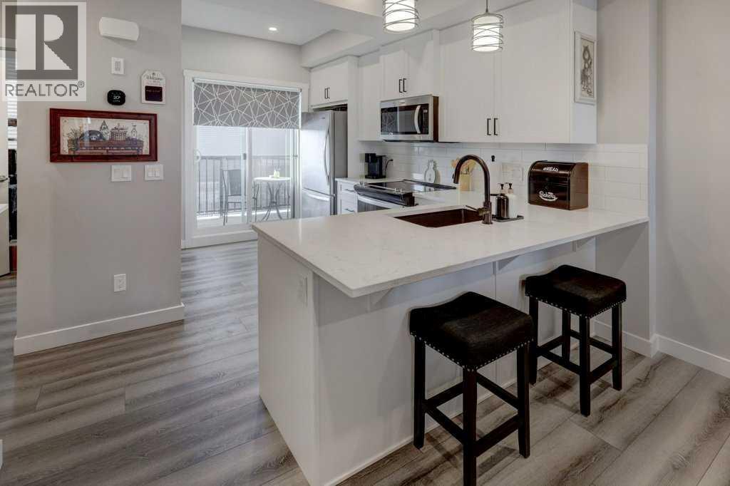 703, 115 Sagewood Drive Sw, Airdrie, AB - Indoor Photo Showing Kitchen With Upgraded Kitchen