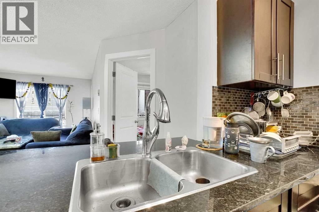 411, 15 Saddlestone Way Ne, Calgary, AB - Indoor Photo Showing Kitchen With Double Sink