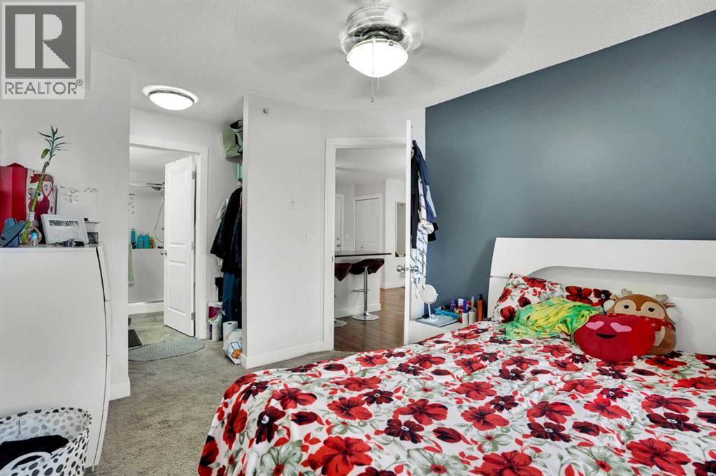 PRIMARY BEDROOM - 411, 15 Saddlestone Way Ne, Calgary, AB - Indoor Photo Showing Bedroom