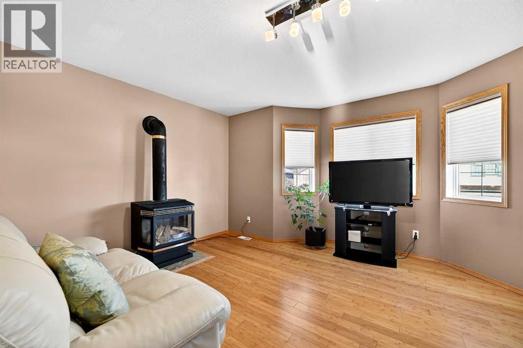 30 Tuscarora Way Nw, Calgary, AB - Indoor Photo Showing Living Room With Fireplace