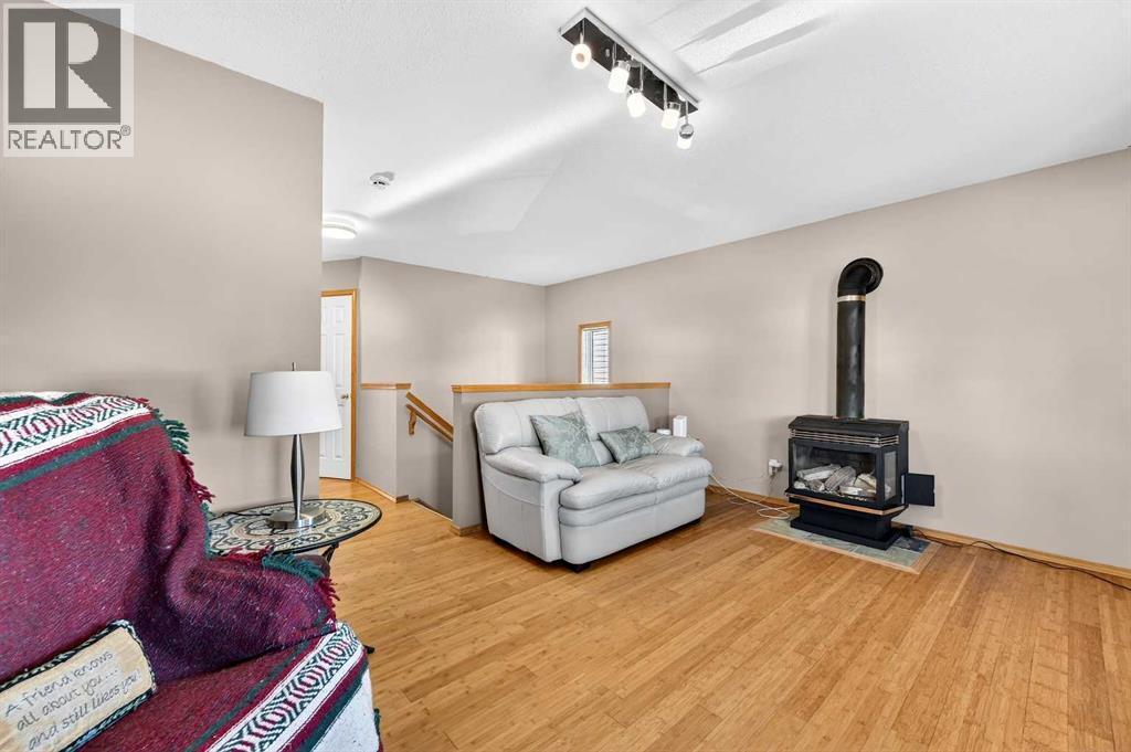 30 Tuscarora Way Nw, Calgary, AB - Indoor Photo Showing Living Room With Fireplace
