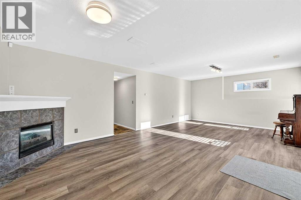 30 Tuscarora Way Nw, Calgary, AB - Indoor Photo Showing Living Room With Fireplace
