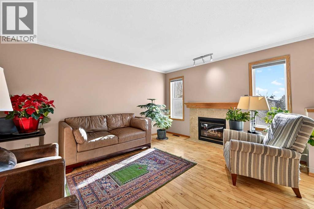 30 Tuscarora Way Nw, Calgary, AB - Indoor Photo Showing Living Room With Fireplace