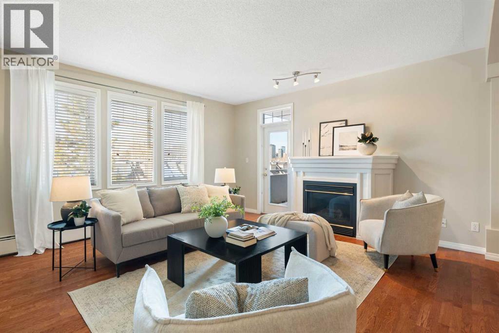 404, 2422 Erlton Street Sw, Calgary, AB - Indoor Photo Showing Living Room With Fireplace