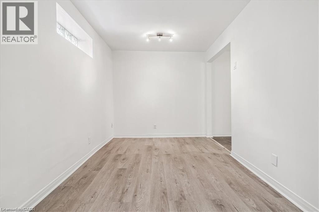 Spare room with light wood finished floors and baseboards - 28 Grove Street, Hamilton, ON - Indoor Photo Showing Other Room