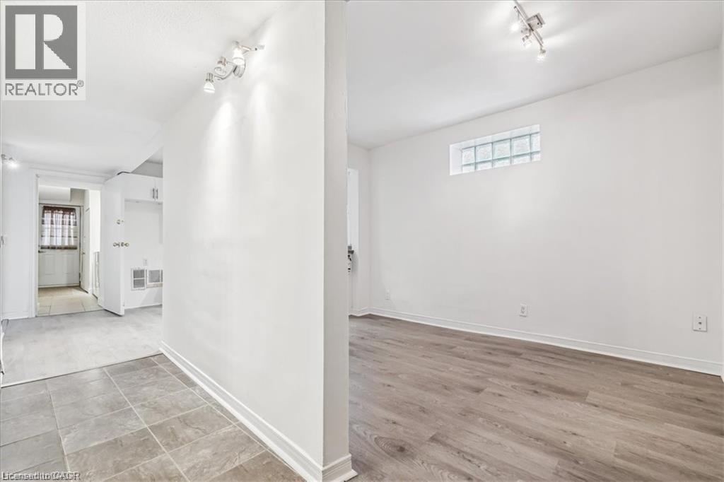 Hall featuring healthy amount of natural light and rail lighting - 28 Grove Street, Hamilton, ON - Indoor Photo Showing Other Room