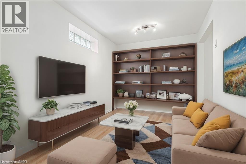 Living room with light wood-style flooring and rail lighting - 28 Grove Street, Hamilton, ON - Indoor Photo Showing Living Room