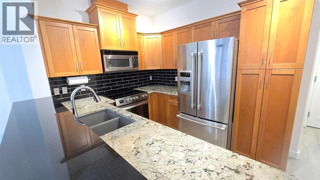 201, 10 Discovery Ridge Close Sw, Calgary, AB - Indoor Photo Showing Kitchen With Stainless Steel Kitchen With Double Sink