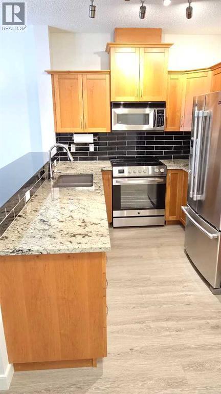 201, 10 Discovery Ridge Close Sw, Calgary, AB - Indoor Photo Showing Kitchen With Stainless Steel Kitchen