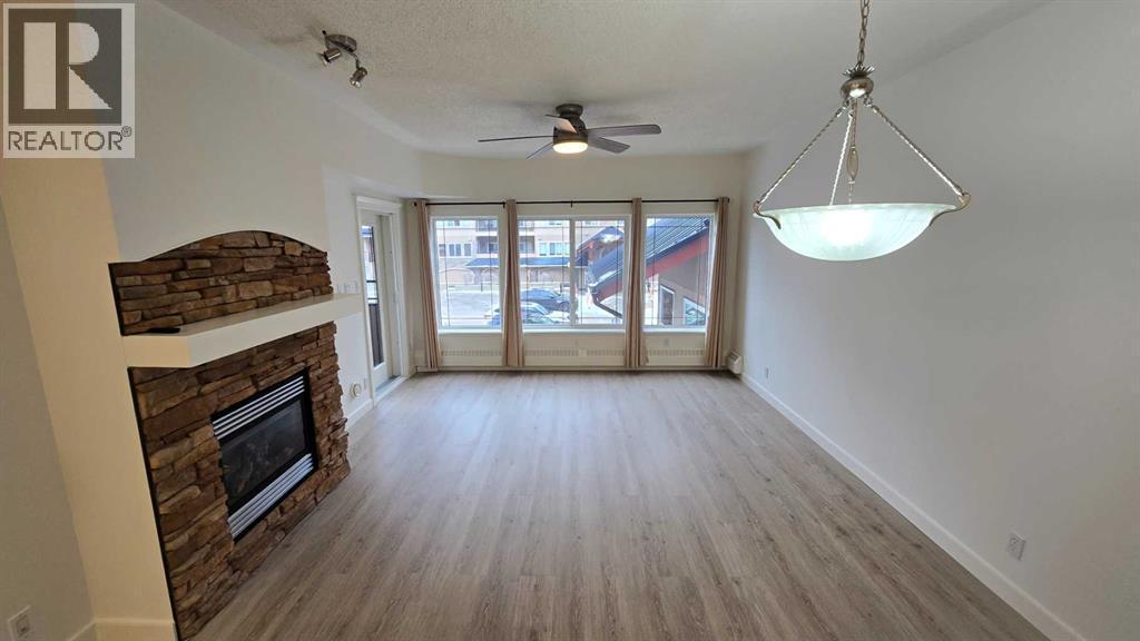 201, 10 Discovery Ridge Close Sw, Calgary, AB - Indoor Photo Showing Other Room With Fireplace