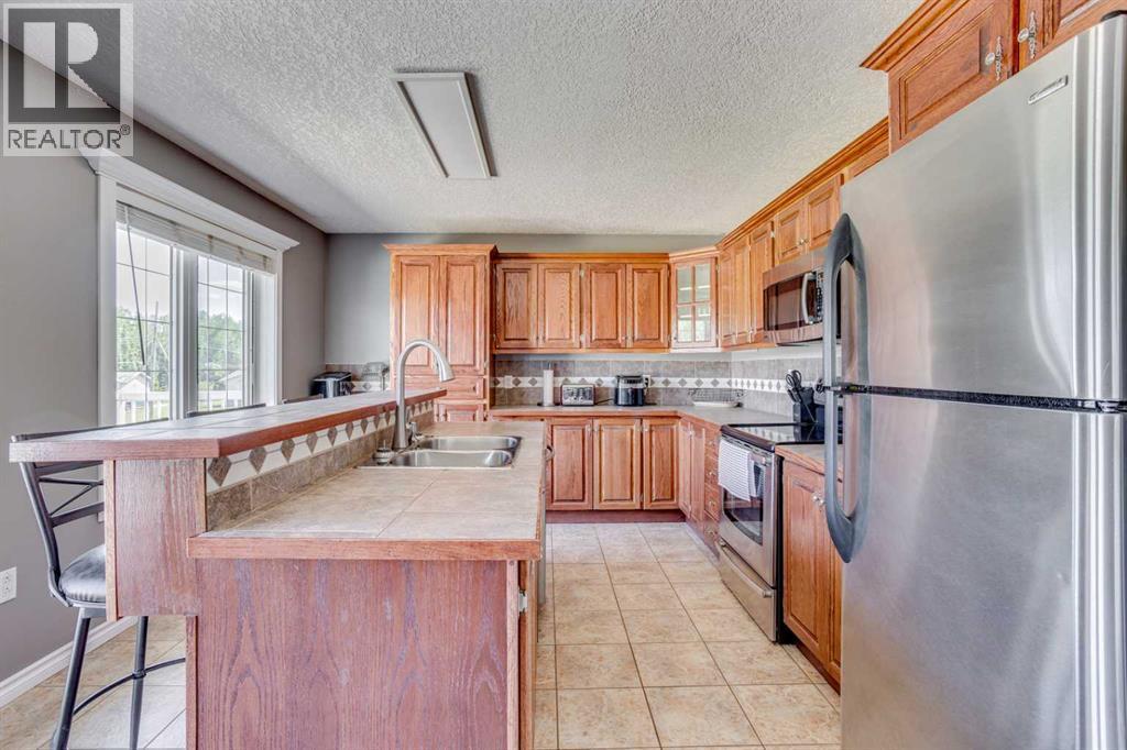 117 Cheecham Court, Anzac, AB - Indoor Photo Showing Kitchen With Stainless Steel Kitchen With Double Sink