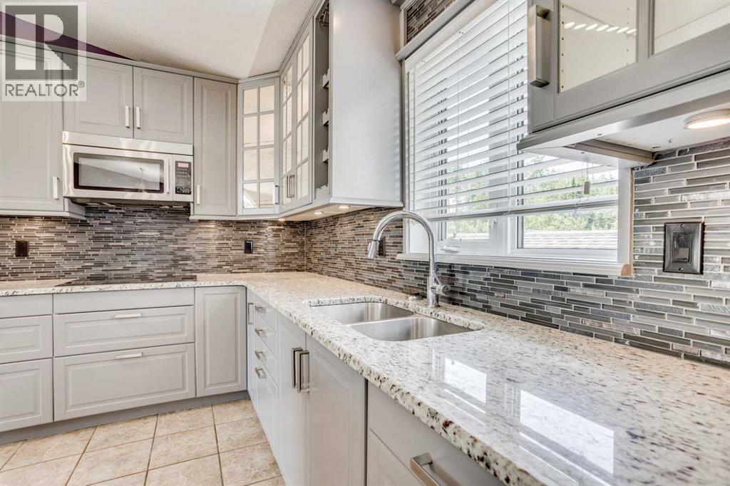 117 Cheecham Court, Anzac, AB - Indoor Photo Showing Kitchen With Double Sink With Upgraded Kitchen