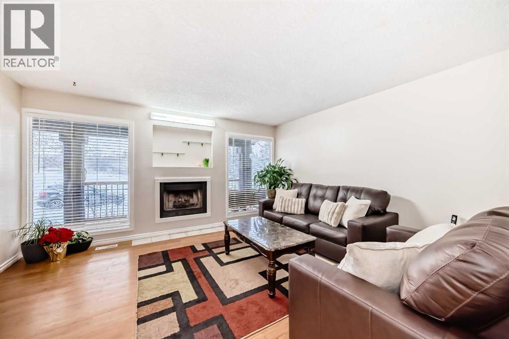 Bright windows - 562 Strathcona Drive Sw, Calgary, AB - Indoor Photo Showing Living Room With Fireplace