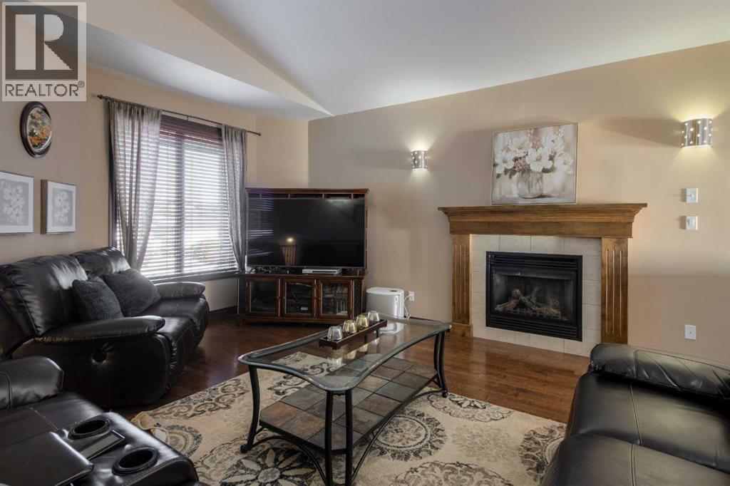 380 Grizzly Crescent N, Lethbridge, AB - Indoor Photo Showing Living Room With Fireplace
