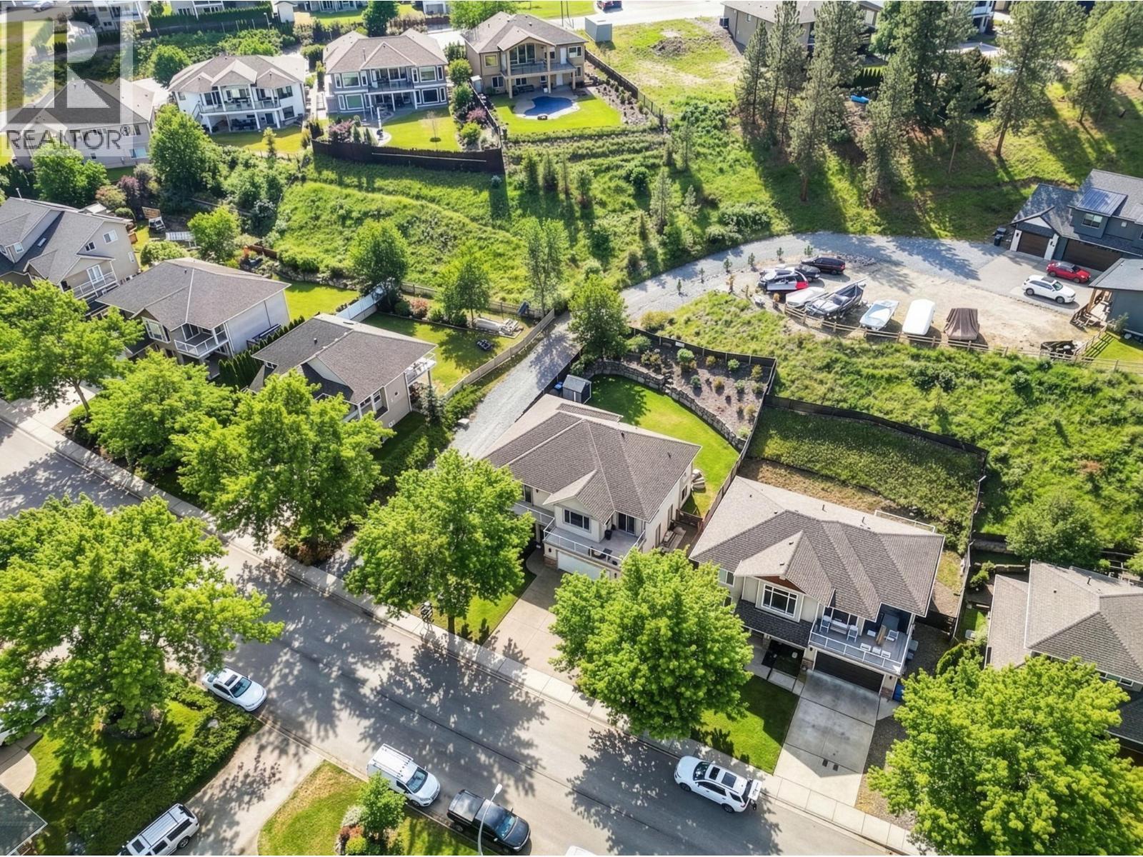 Exterior landscaping has been digitally enhanced to reflect summer conditions. Photos were taken during the winter season. - 867 Steele Road, Kelowna, BC - Outdoor With View