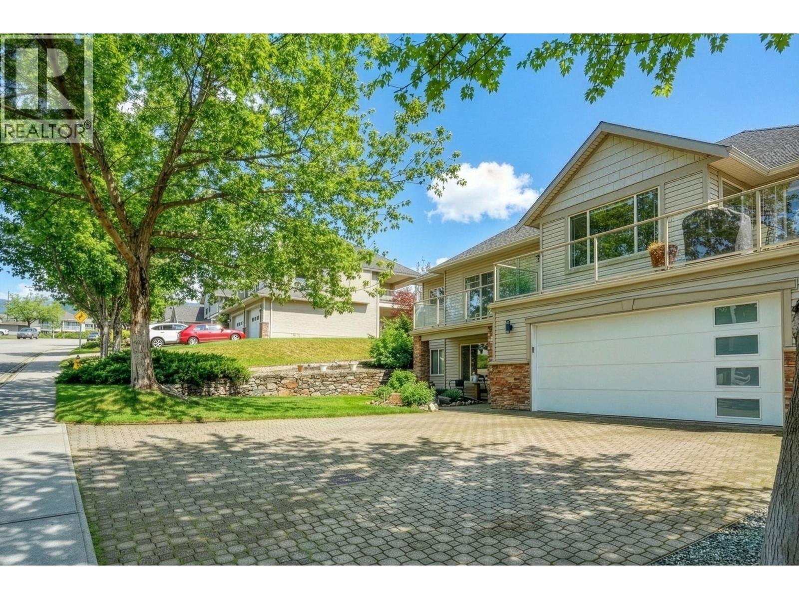 Exterior landscaping has been digitally enhanced to reflect summer conditions. Photos were taken during the winter season. - 867 Steele Road, Kelowna, BC - Outdoor