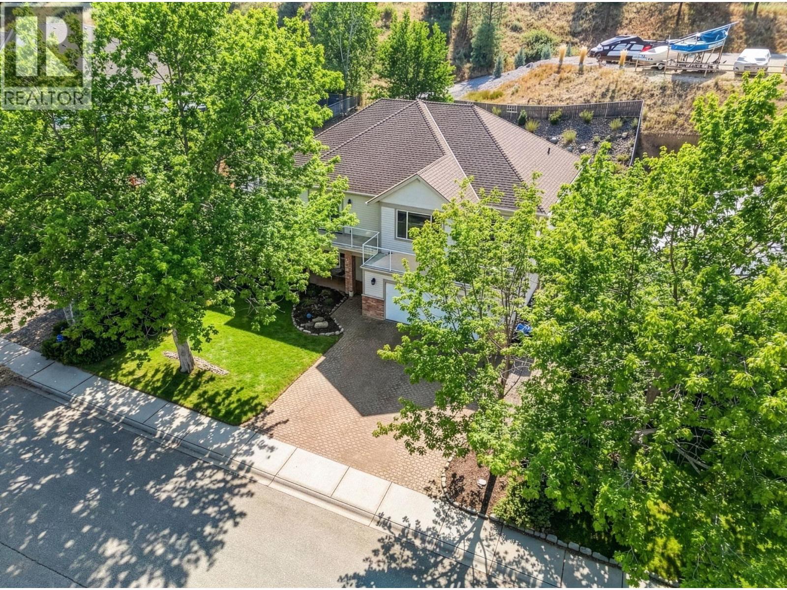 Exterior landscaping has been digitally enhanced to reflect summer conditions. Photos were taken during the winter season. - 867 Steele Road, Kelowna, BC - Outdoor