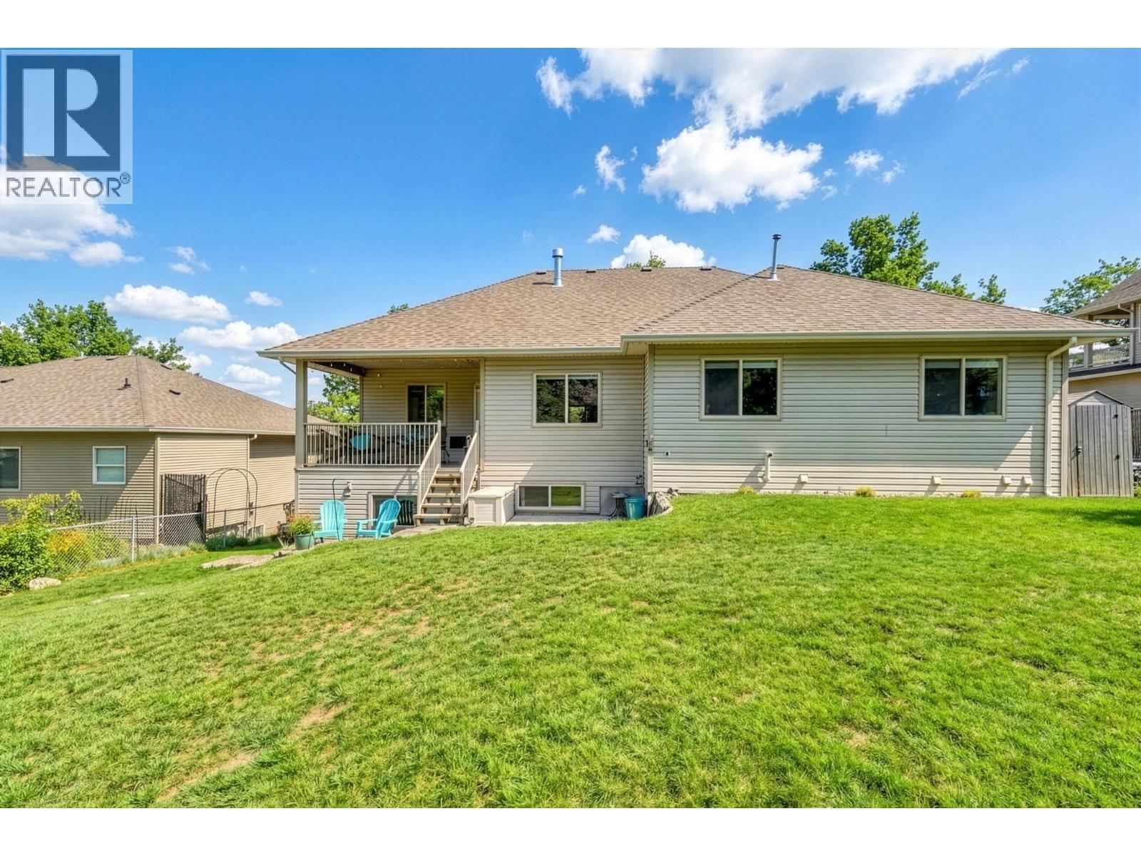 Backyard. Exterior landscaping has been digitally enhanced to reflect summer conditions. Photos were taken during the winter season. Original photos available upon request. - 867 Steele Road, Kelowna, BC - Outdoor With Exterior