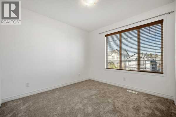 Bedroom 3 - 345 Prestwick Terrace Se, Calgary, AB - Indoor Photo Showing Other Room
