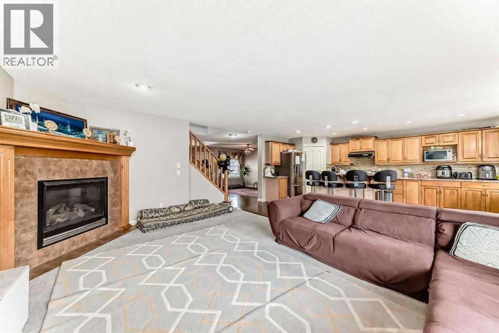 2468 Kingsland View Se, Airdrie, AB - Indoor Photo Showing Living Room With Fireplace