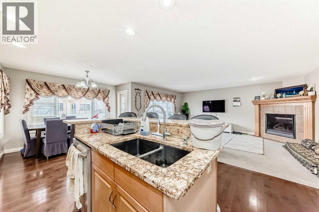 2468 Kingsland View Se, Airdrie, AB - Indoor Photo Showing Kitchen With Fireplace With Double Sink