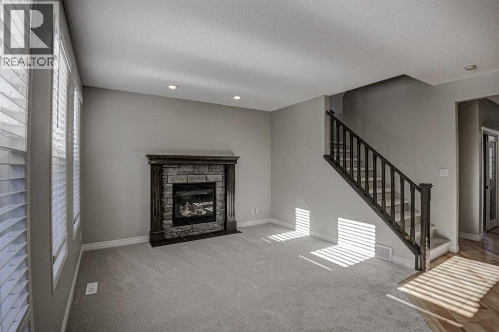 40 Prestwick Manor Se, Calgary, AB - Indoor Photo Showing Living Room With Fireplace
