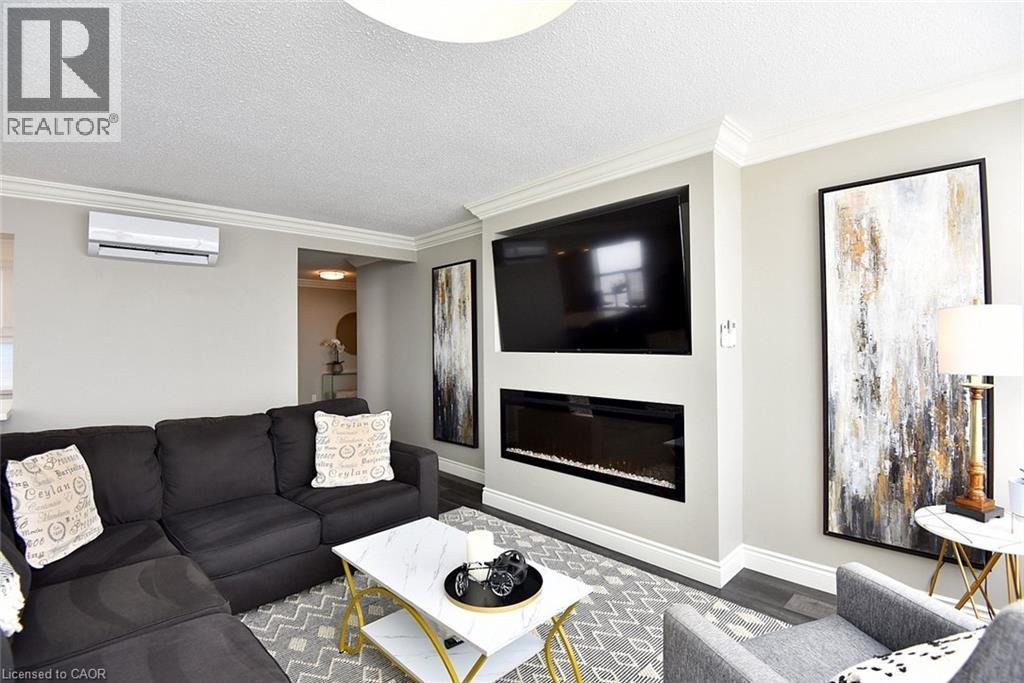 75 Queen Street N Unit# 1707, Hamilton, ON - Indoor Photo Showing Living Room With Fireplace