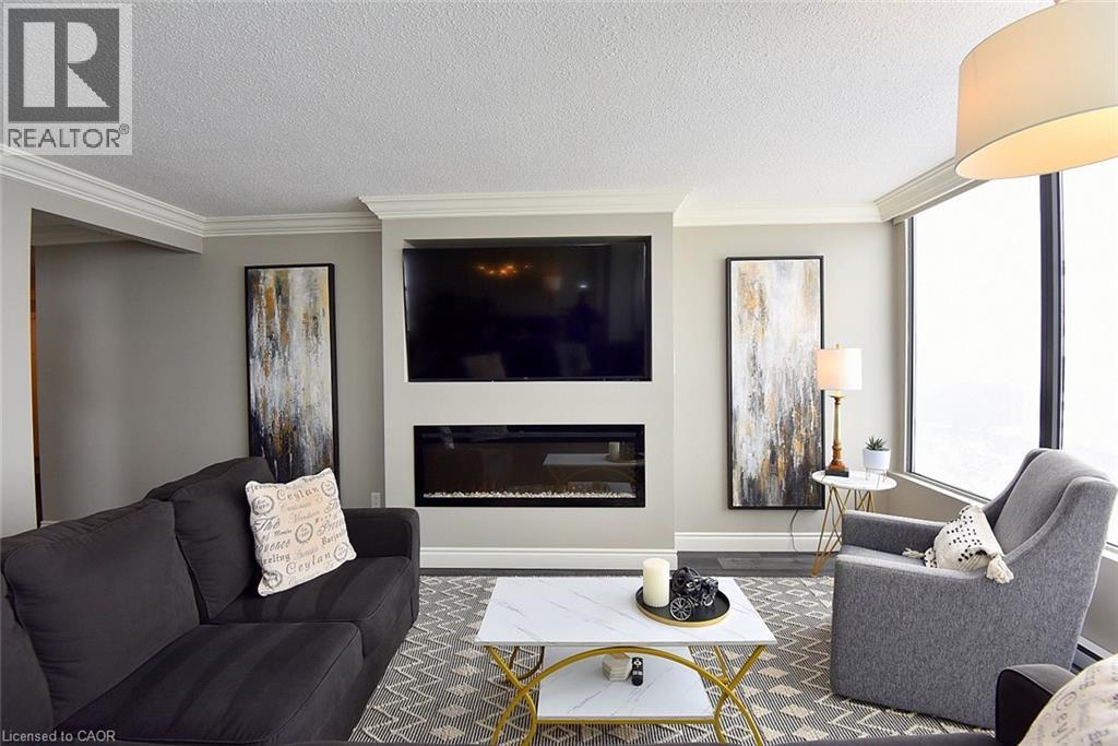 75 Queen Street N Unit# 1707, Hamilton, ON - Indoor Photo Showing Living Room With Fireplace