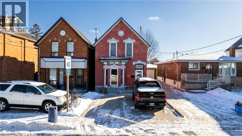 View of front facade with brick siding - 126 Tisdale Street N, Hamilton, ON - Outdoor With Facade