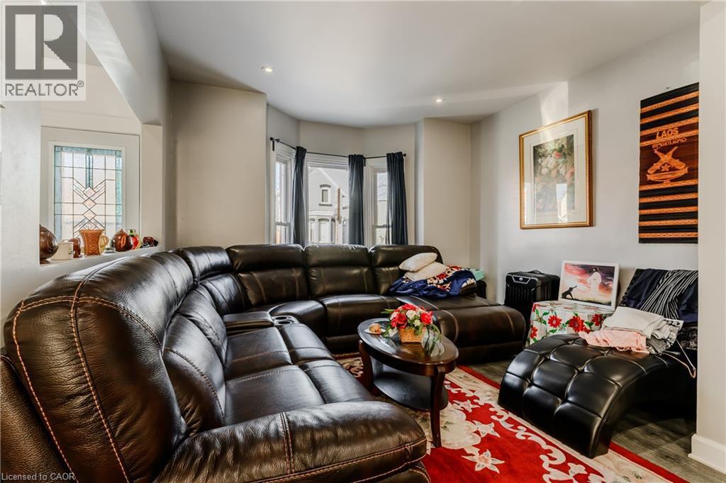 Living area with plenty of natural light, recessed lighting, and wood finished floors - 126 Tisdale Street N, Hamilton, ON - Indoor Photo Showing Living Room