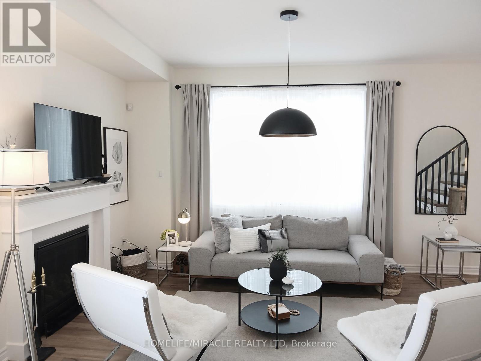919 Ash Gate, Milton, ON - Indoor Photo Showing Living Room With Fireplace