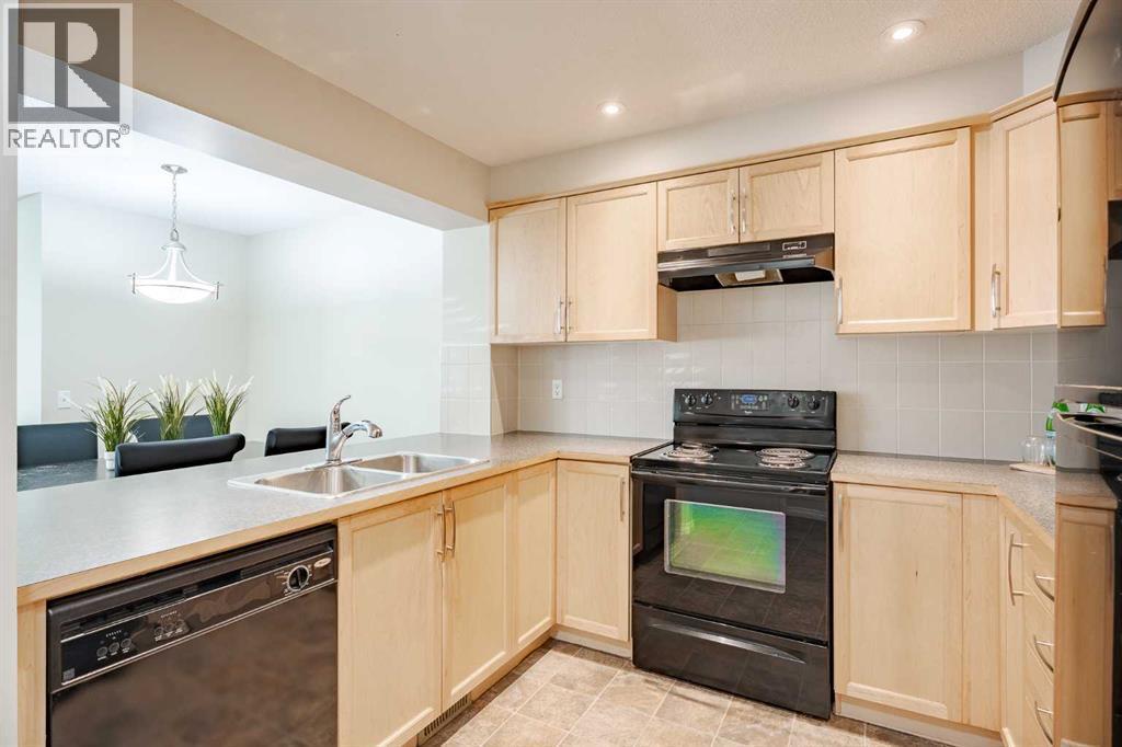 3005 Windsong Boulevard Sw, Airdrie, AB - Indoor Photo Showing Kitchen With Double Sink