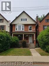 Bungalow-style house featuring a porch and a front yard - 180 Emerald Street S, Hamilton, ON - Outdoor With Facade