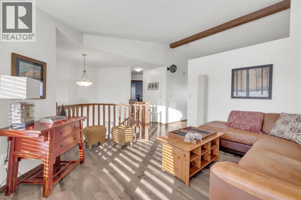 Vaulted Ceiling with Wood Beam - 10 Wilkinson Circle, Sylvan Lake, AB - Indoor Photo Showing Living Room