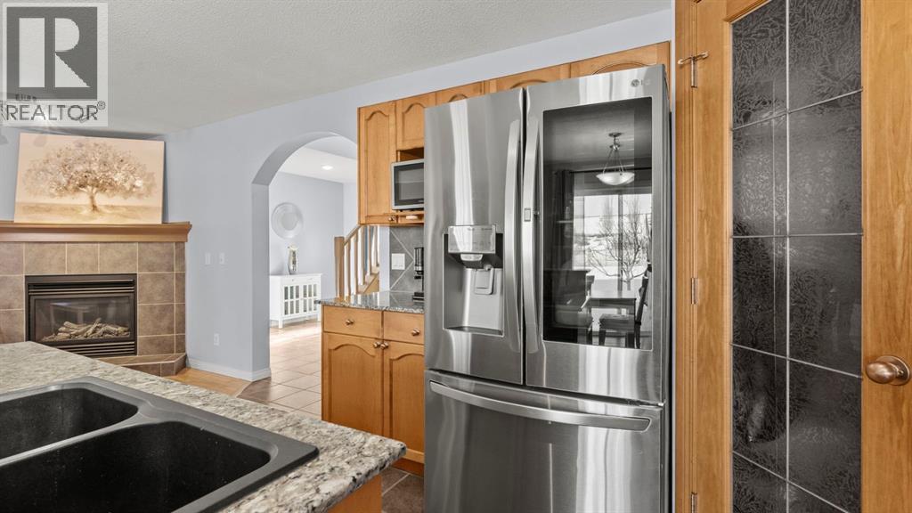 158 Covemeadow Road Ne, Calgary, AB - Indoor Photo Showing Kitchen With Fireplace With Double Sink