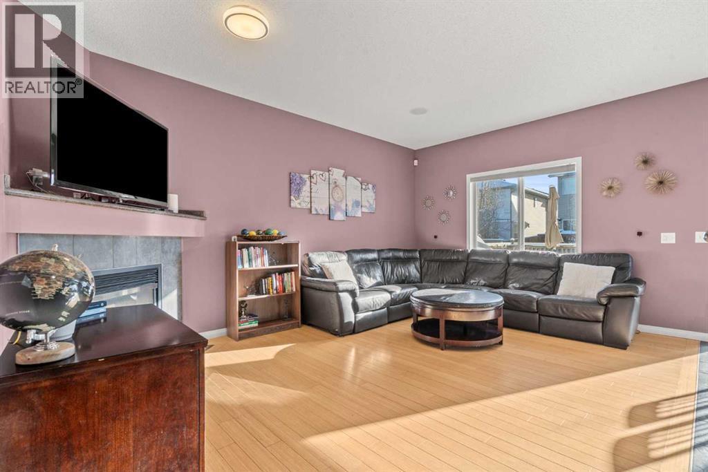 15 Chapalina Close Se, Calgary, AB - Indoor Photo Showing Living Room With Fireplace